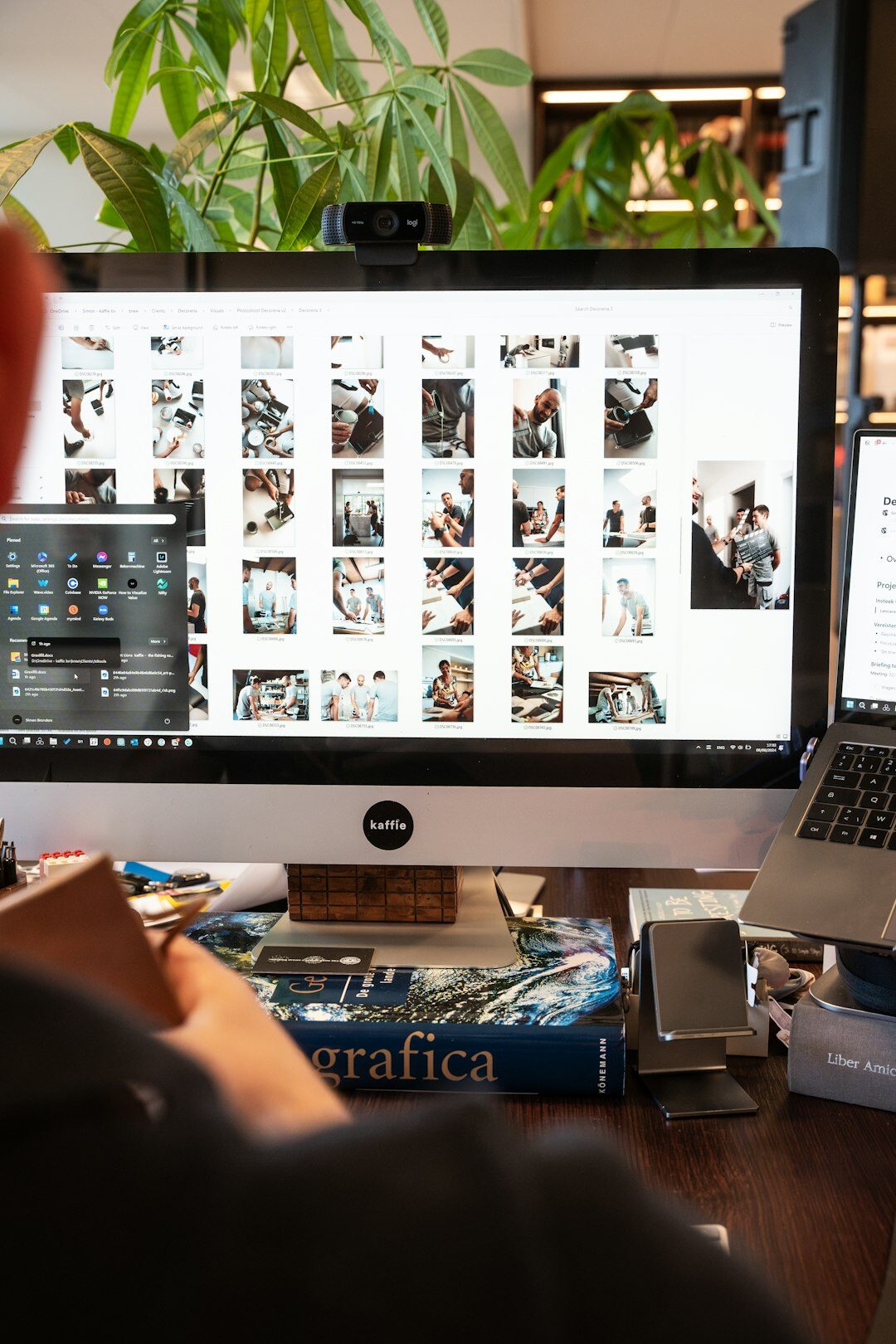 Diverse editorial team collaborating around a table with monitors